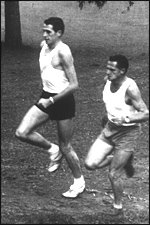 A 1962 file picture of (left) John Davies and coach Arthur Lydiard tackiling an uphill slope on a golf course. Davies a Tokoroa school teacher, is taking holidays in Auckland and Mr Lyiard has been given time with him by his employers Rothmans ltd... New Zealand Herald Picture   scanned 24JULY2003 NZH 26jul03 - MENTOR : John Davies (left) training in 1962 with Arthur Lydiard, who describes his former pupil as sincere, intelligent and with lots of stamina.
